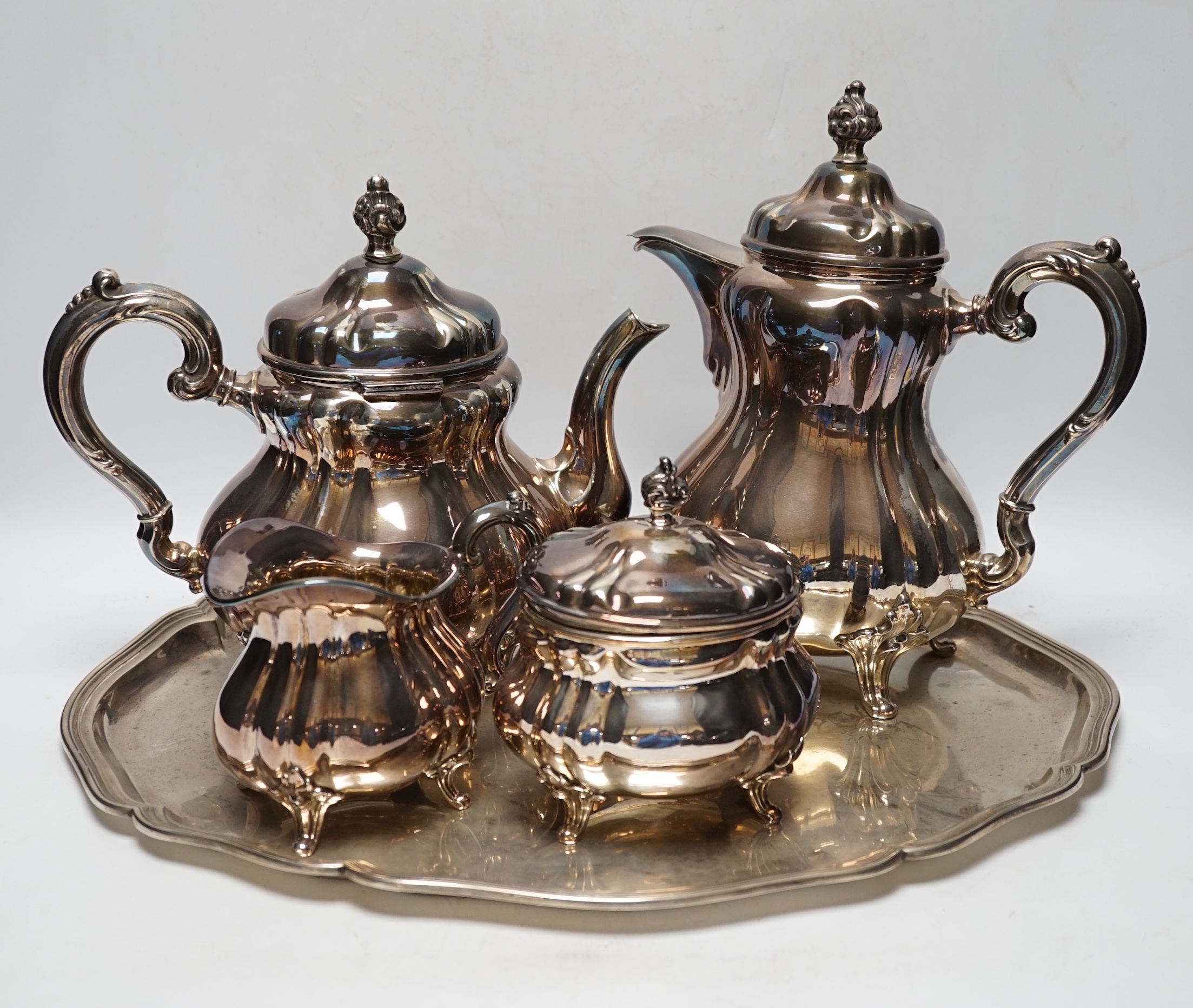 A German 835 standard white metal four piece tea set by Wilhelm Binder and a 830 standard white metal oval tray, gross weight 102.5oz.